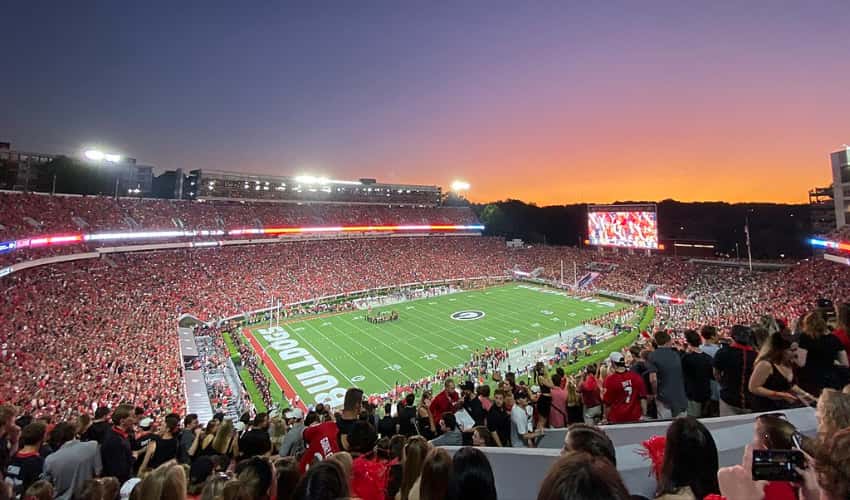 A UGA vs Notre Dame football game with a packed stadium in the evening
