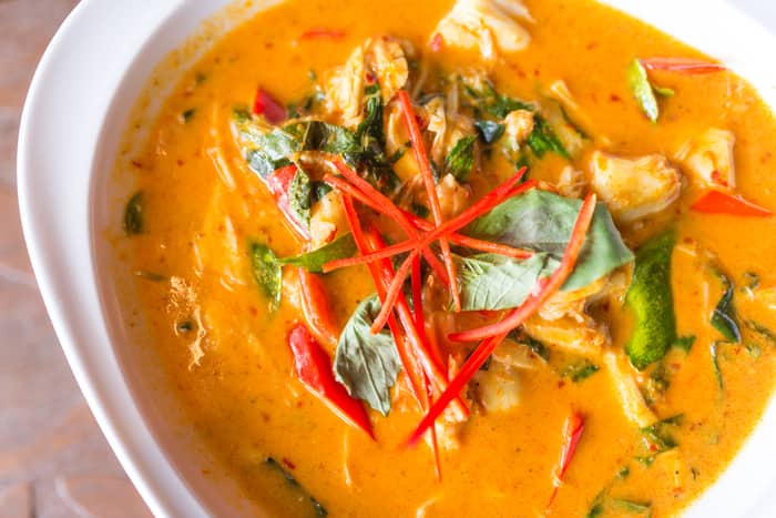 a thai soup dish topped with thinly-sliced peppers
