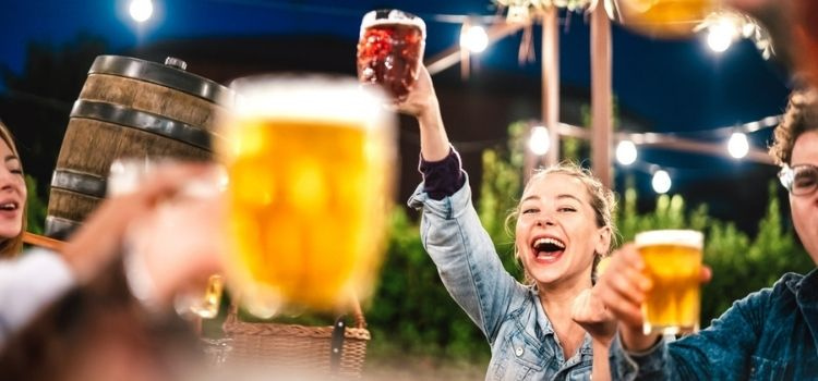 a group of people enjoying beer at a brewery