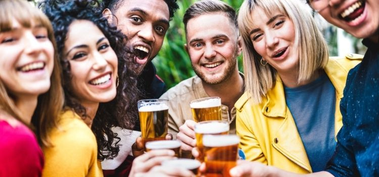 a group of people enjoying beer at a brewery