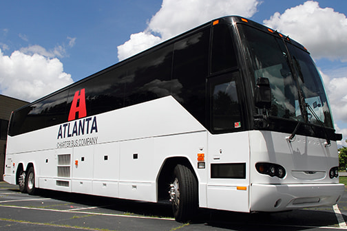 a plain white charter bus with an "Atlanta Charter Bus Company" logo